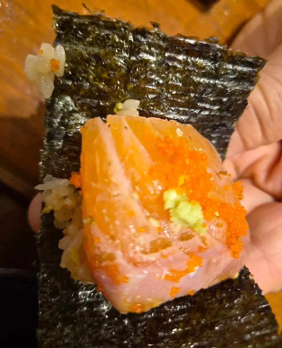 A sheet of seaweed topped with tuna and wasabi to wrap