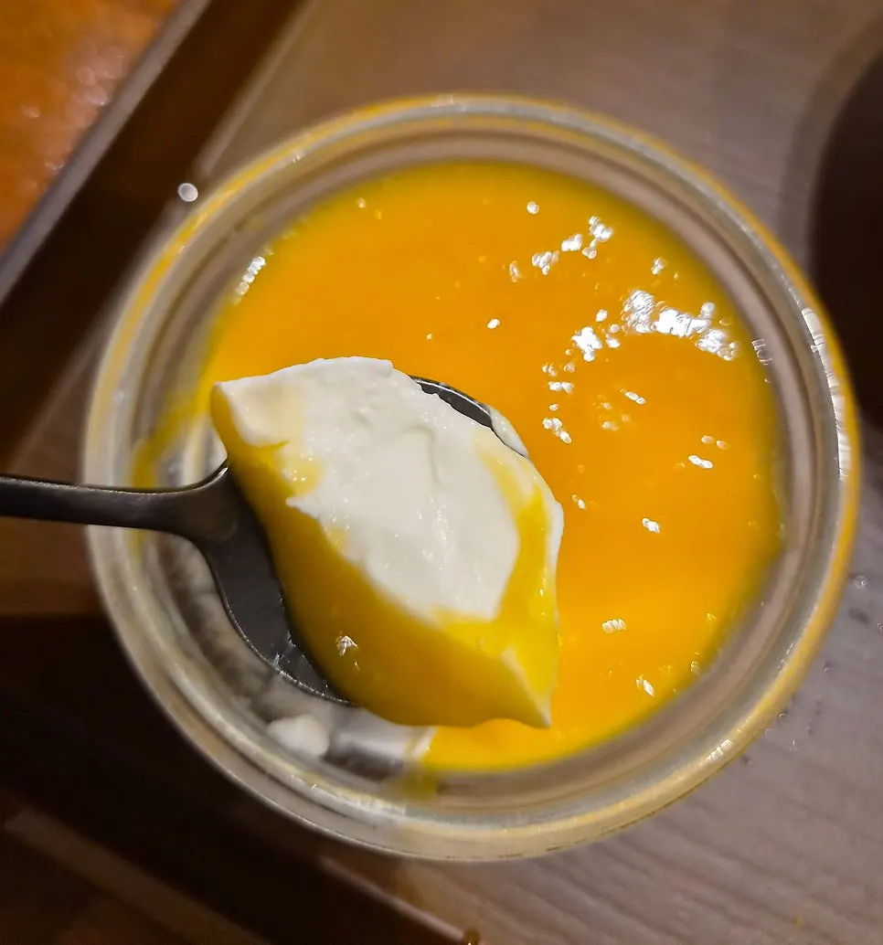 A spoonful of soft mango pudding