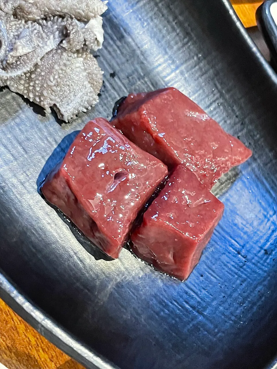 A piece of tripe dipped in sesame oil sauce