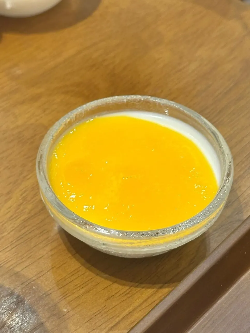 Homemade milk pudding topped with mango purée