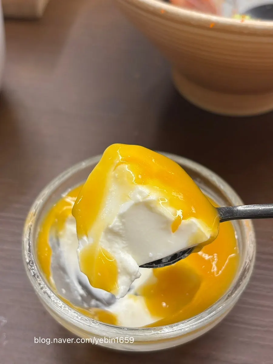 Pannacotta dessert topped with mango sauce