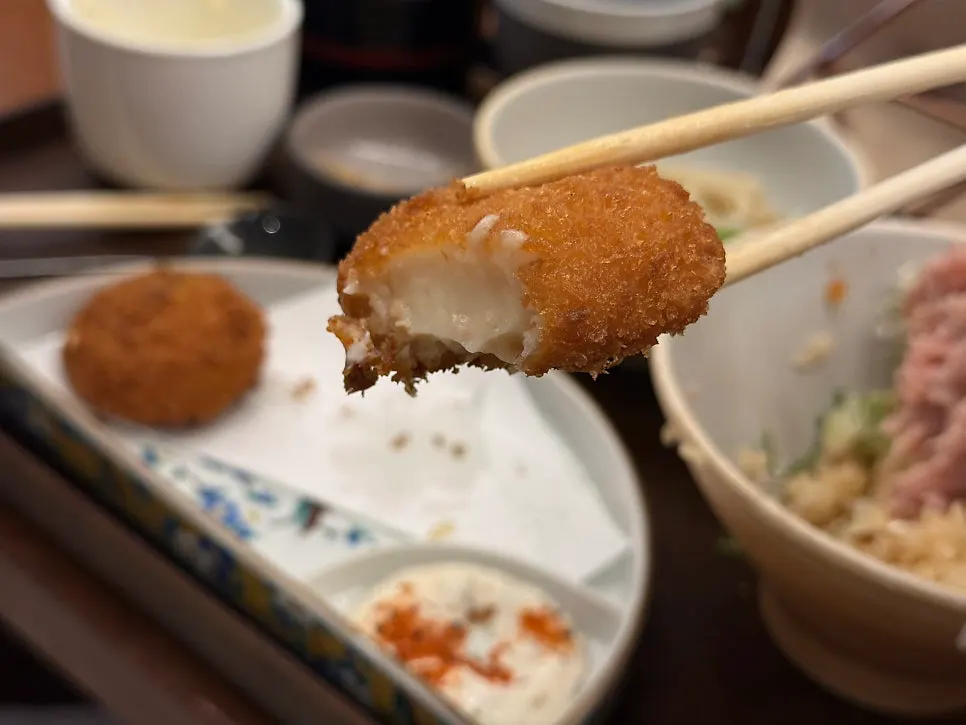A plate with two pieces of croquette
