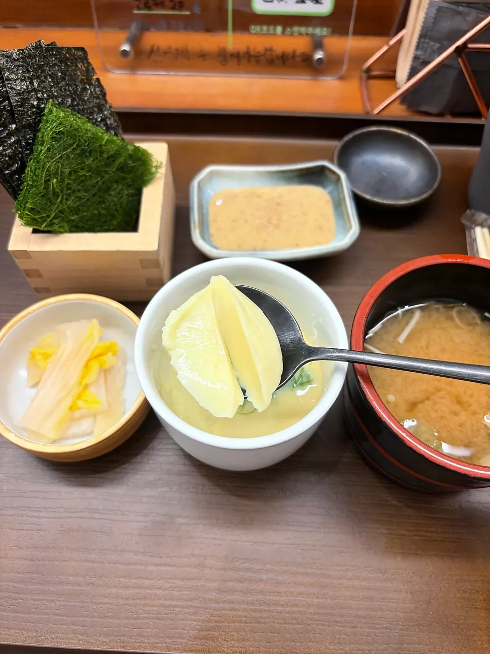 Seaweed, gamtae, white kimchi, and broth soup on the table