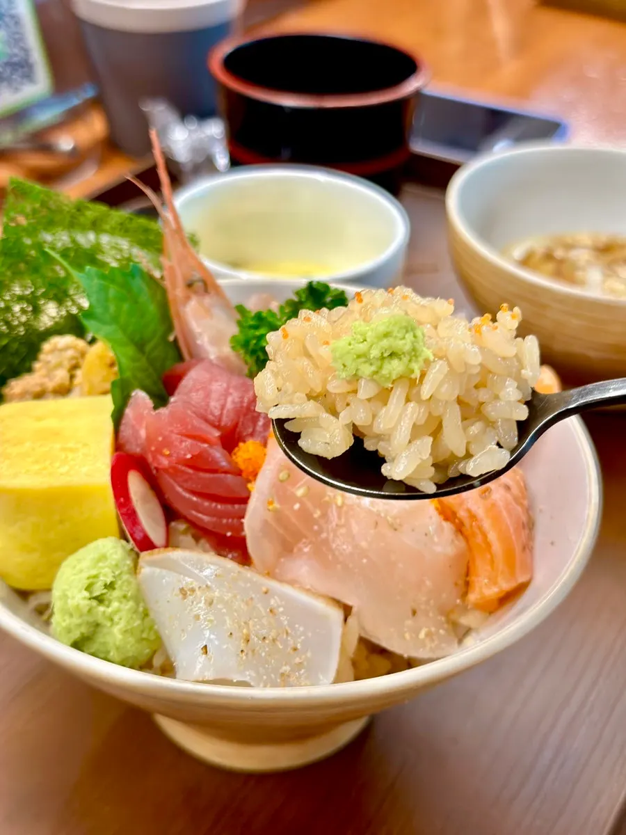 A spoonful of kaisendon mixed with flying fish roe and rice