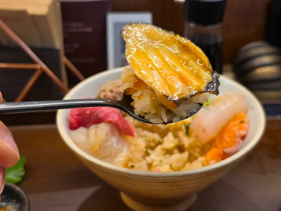 A bite of rice and sashimi wrapped in gim-tae