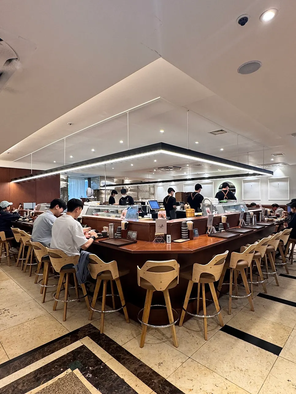 Bar seats wrapped around the U-shaped kitchen