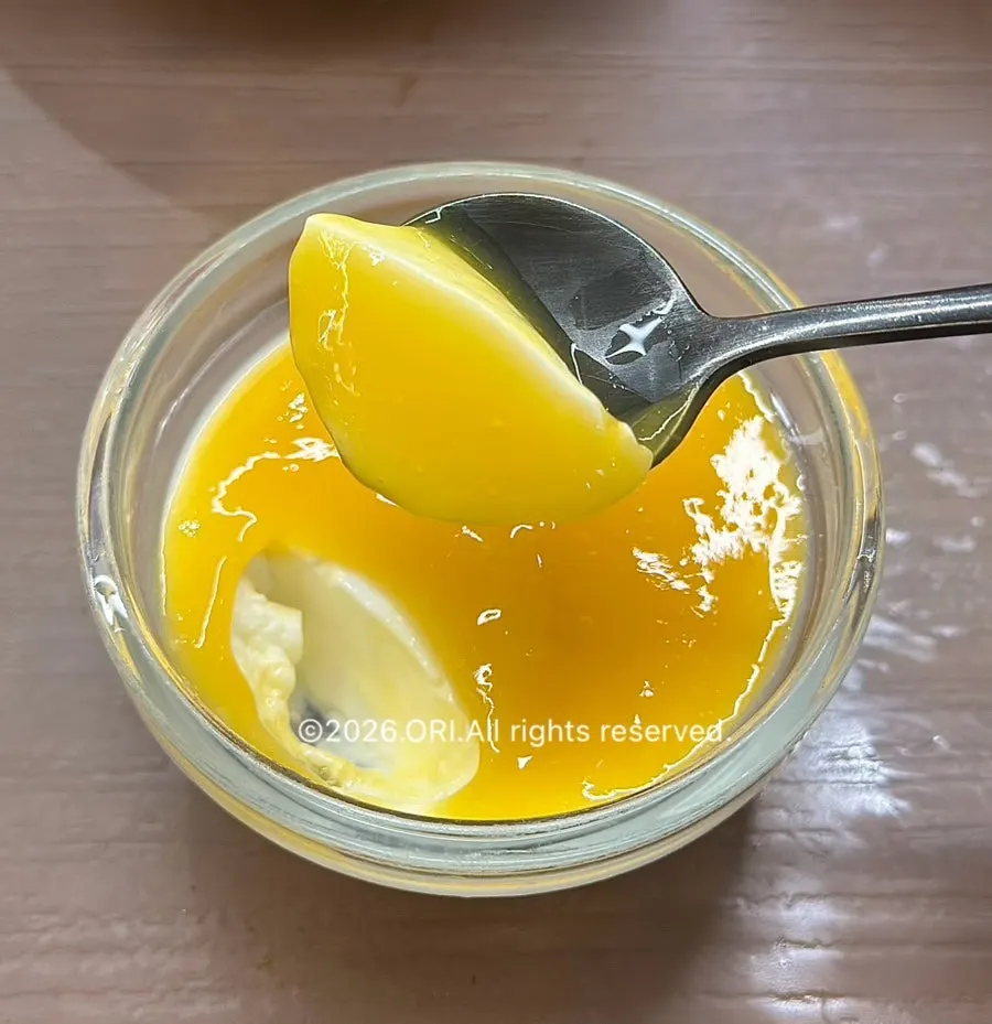 Close-up of pudding topped with mango purée