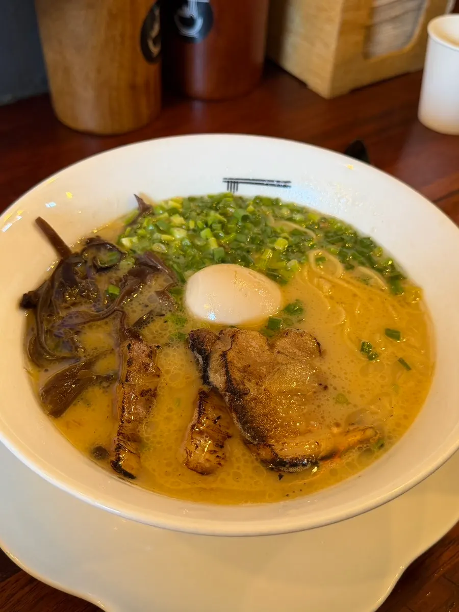 Close-up of a ramen bowl piled with toppings