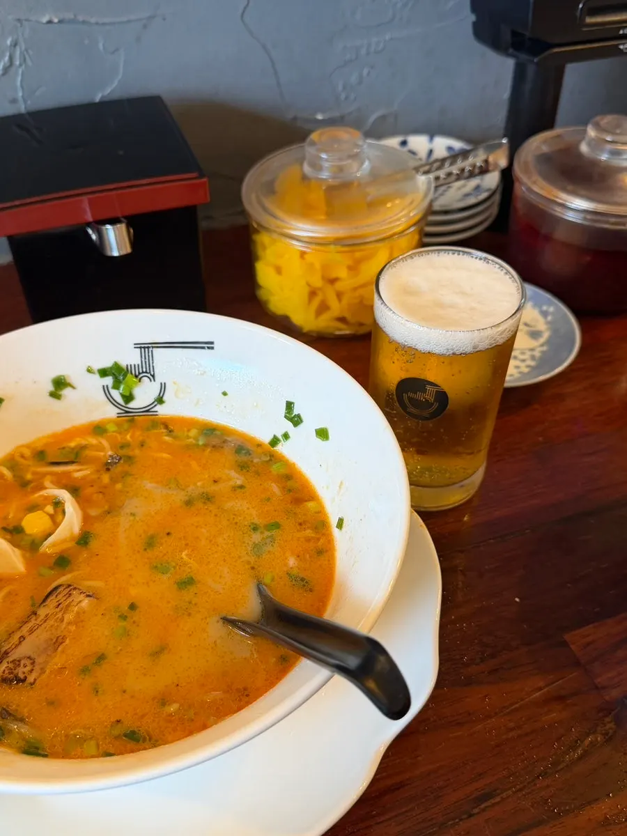 Ramen paired with a Sapporo draft beer
