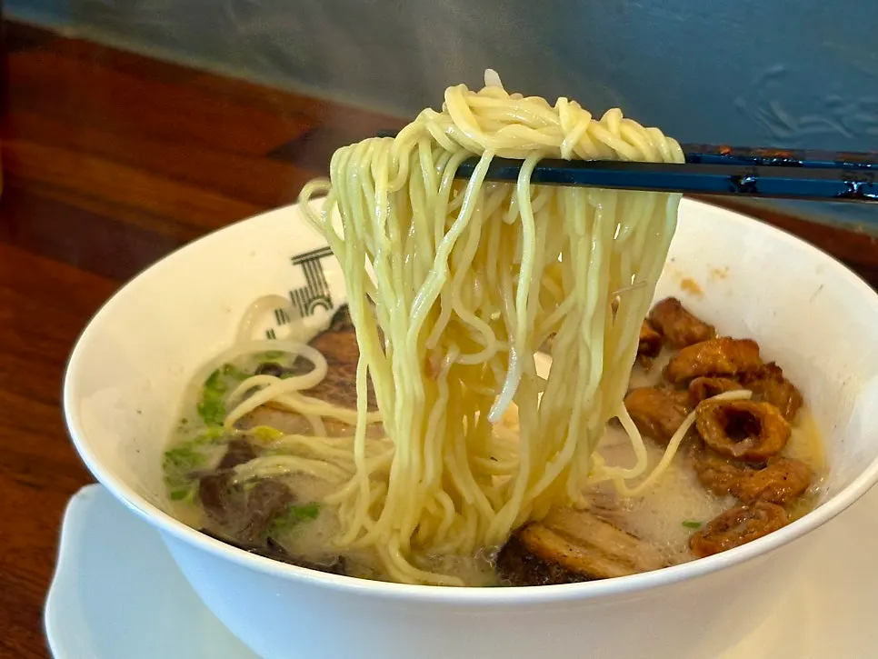Broth and toppings in the Motsu Ramen bowl
