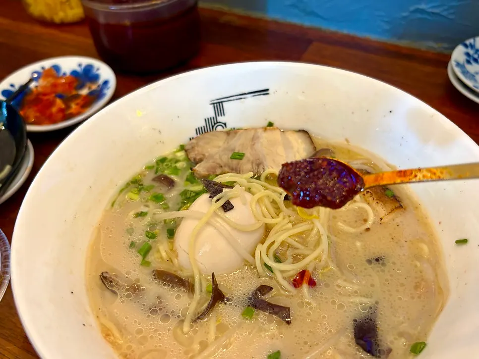 Stirring the spicy seasoning into the ramen