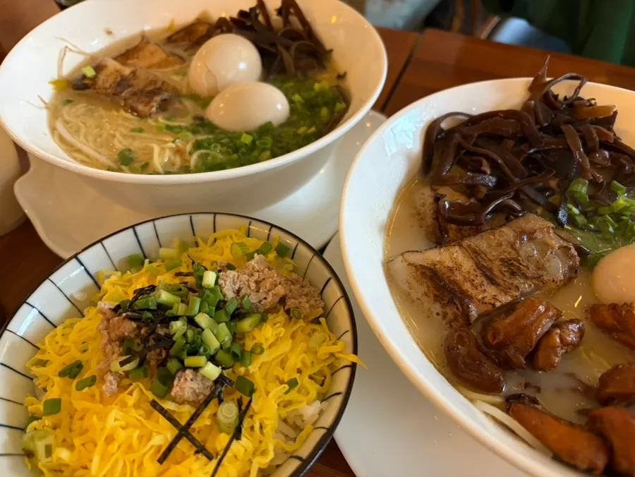 Two bowls of ramen with extra noodles and egg
