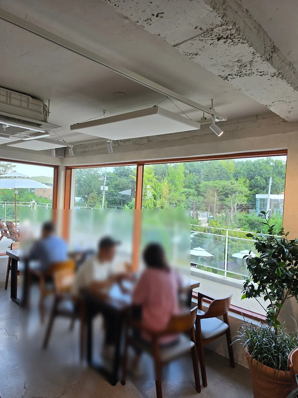 First-floor seats with garden view through floor-to-ceiling windows