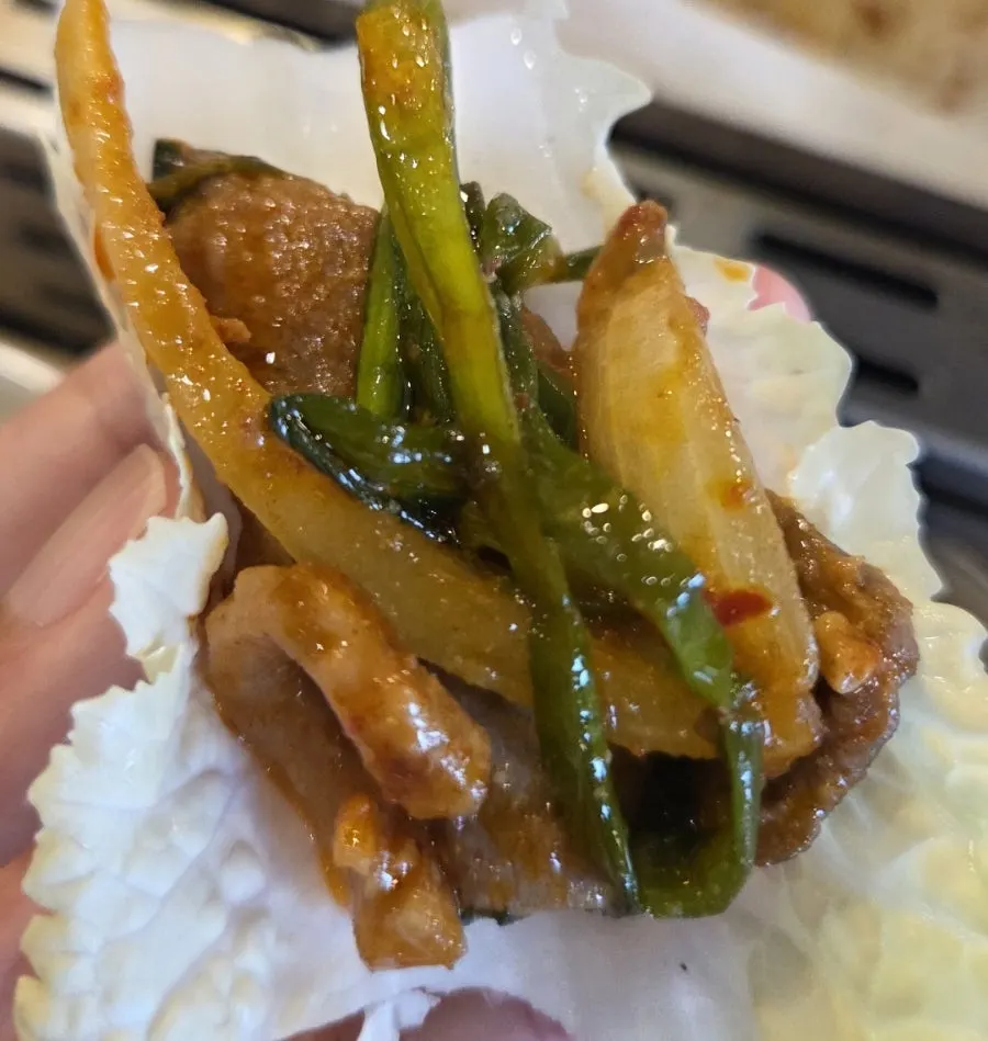 Duck bulgogi stir-fried with a generous pile of vegetables on the grill