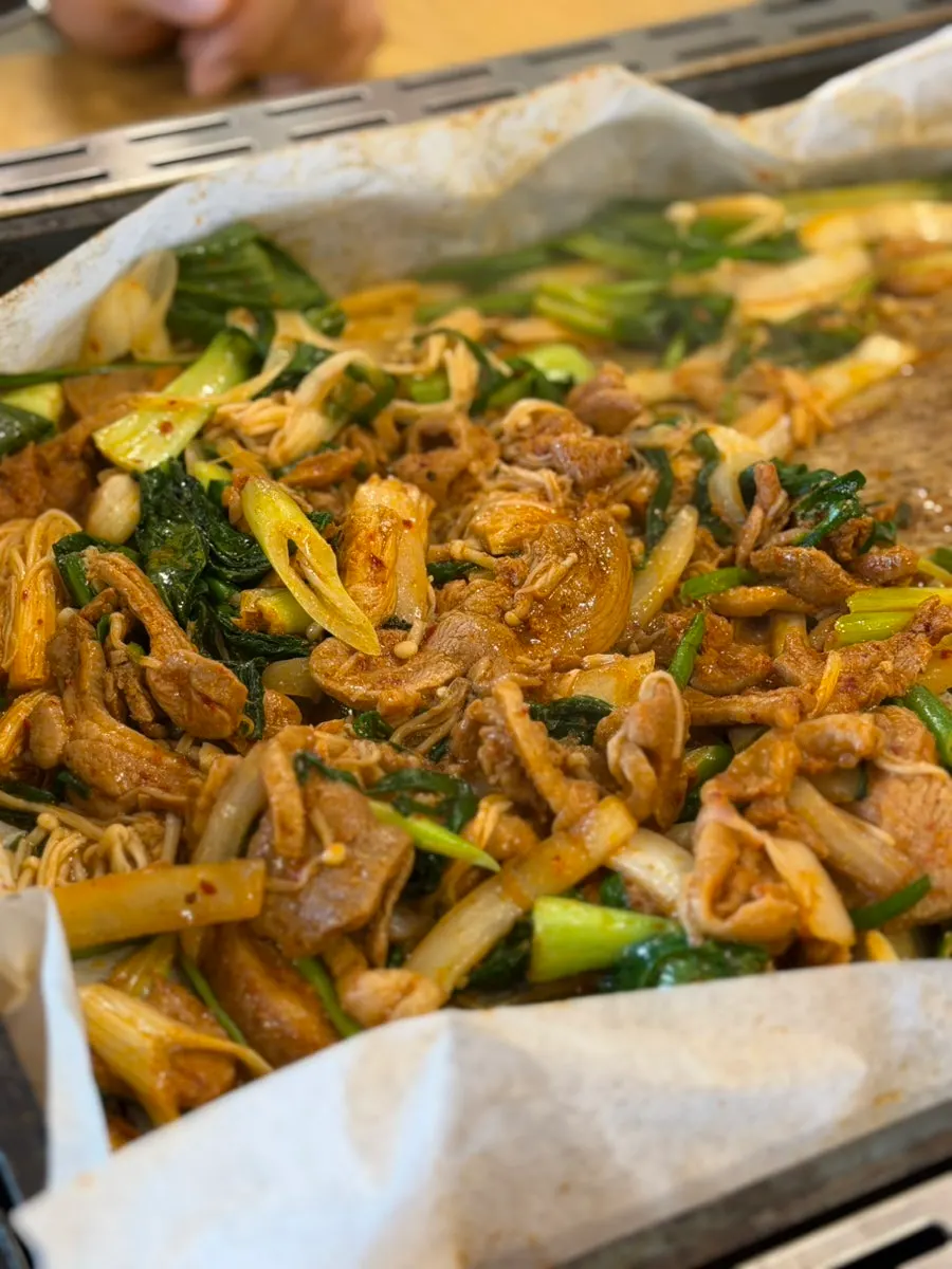Cooked duck bulgogi with garlic chives and bok choy