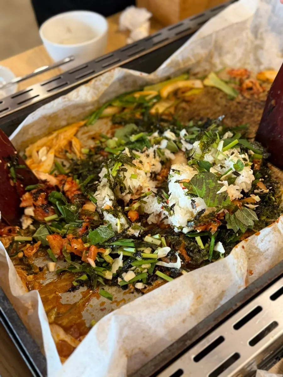 Fried rice ingredients stir-frying on the grill