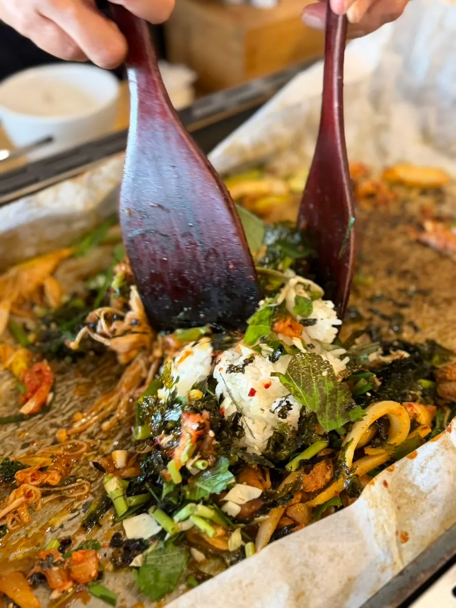Fried rice topped with crushed seaweed and vegetables