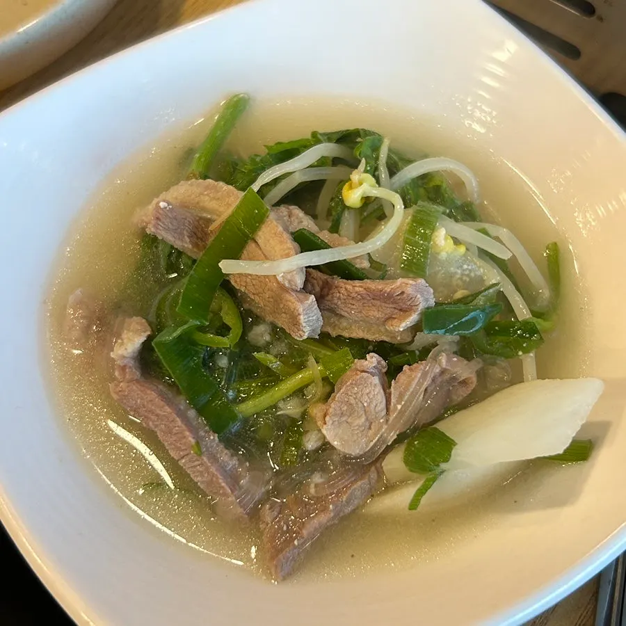 Complimentary duck soup filled with broth and meat