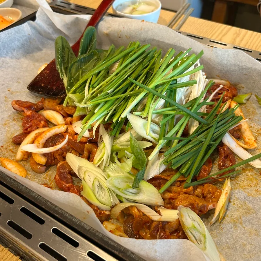 Staff stir-frying spicy duck and vegetables