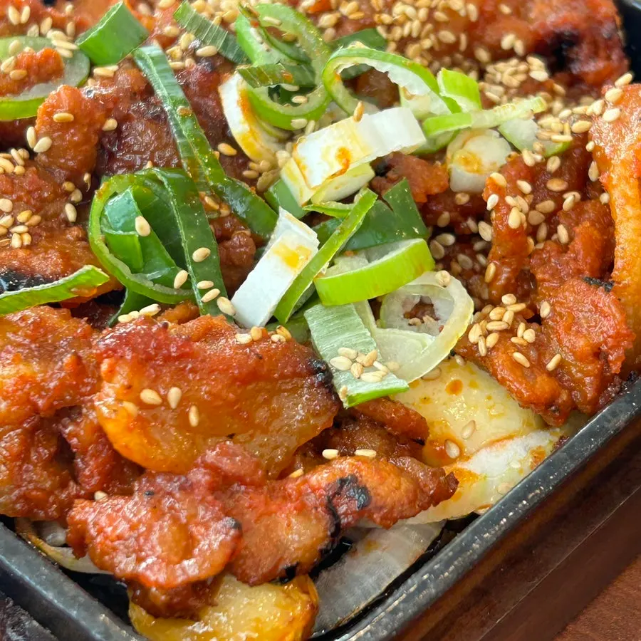 Close-up of pork stir-fry with smoky char flavor