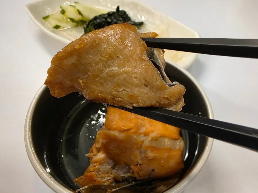 Picking up a piece of grilled salmon