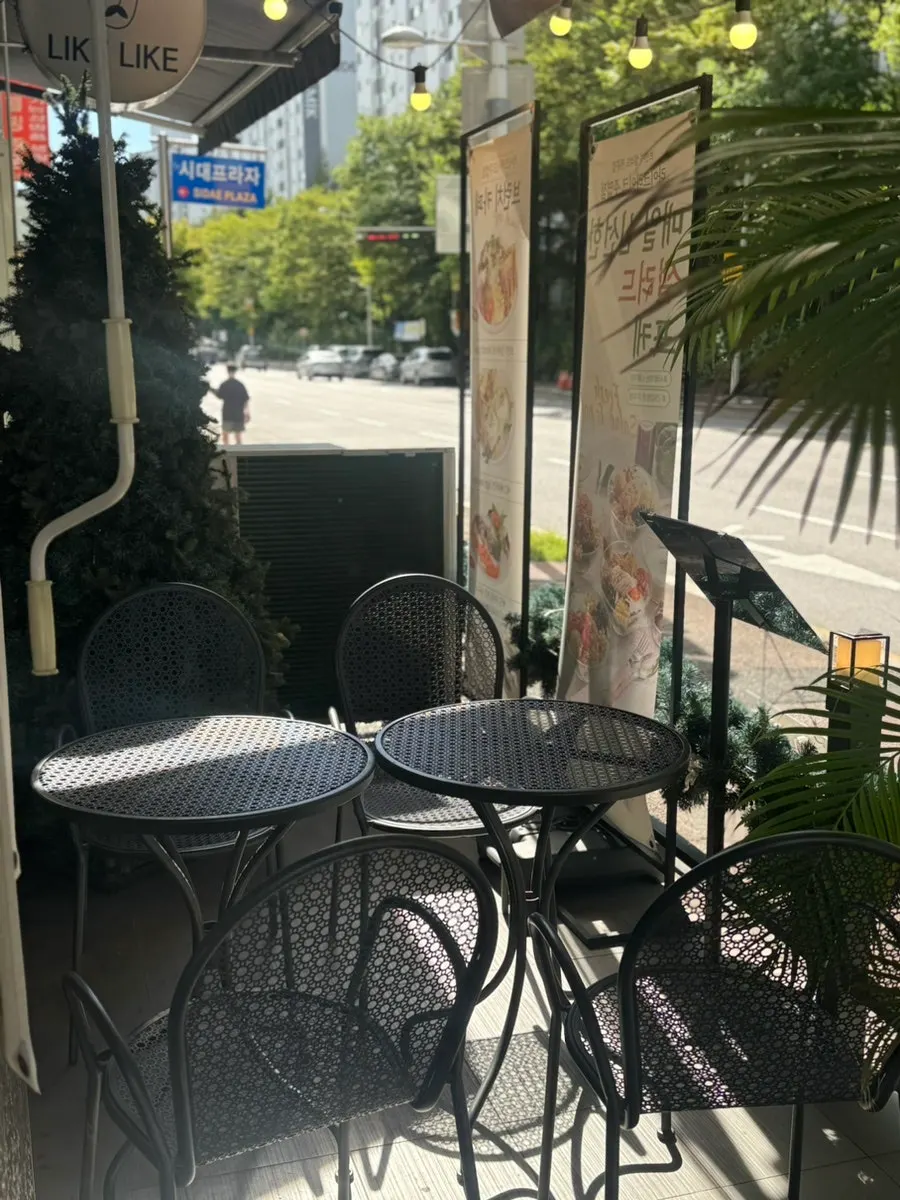 Sunlit outdoor terrace seating at Like Like