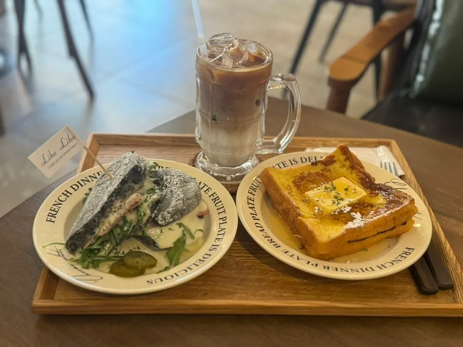 Table spread with panini, French toast, and iced latte