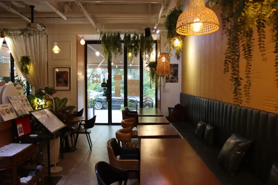 Store interior decorated with plants and rattan lighting