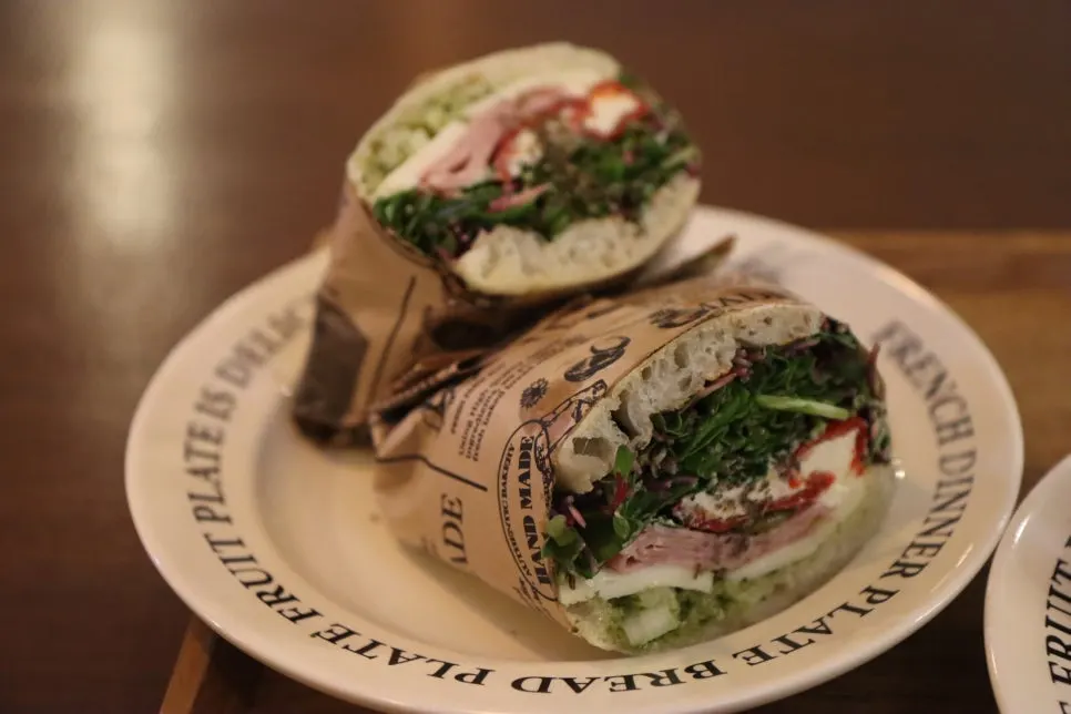 Rugola cream cheese sandwich cut in half and wrapped