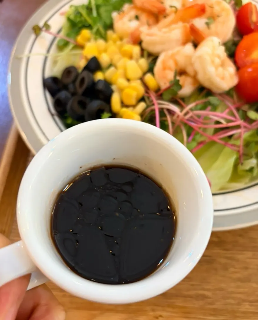 A bite of salad drizzled with balsamic sauce