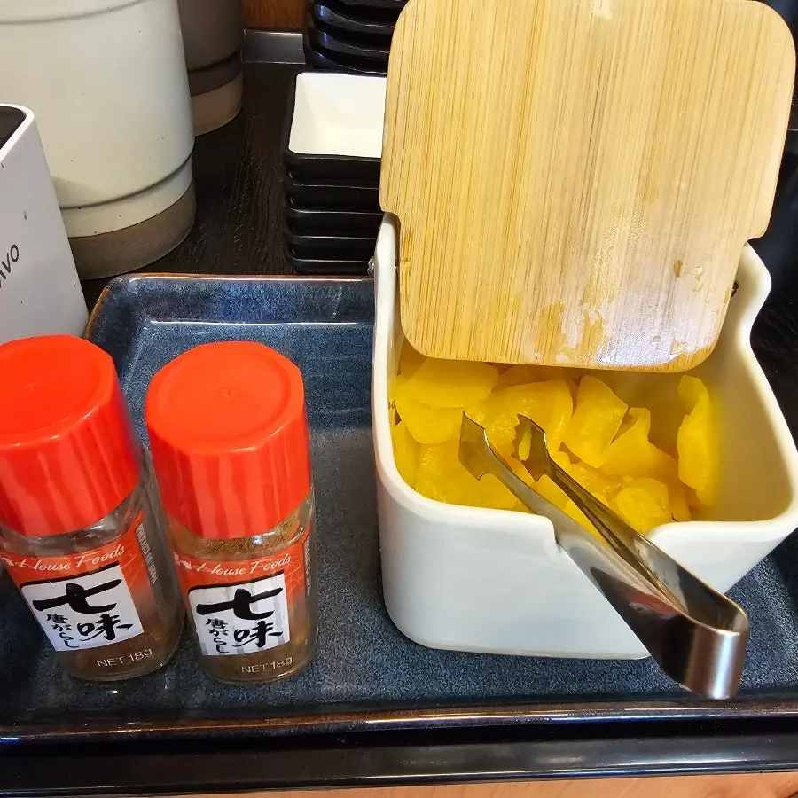 Self-serve bar with pickled radish and shichimi seasoning
