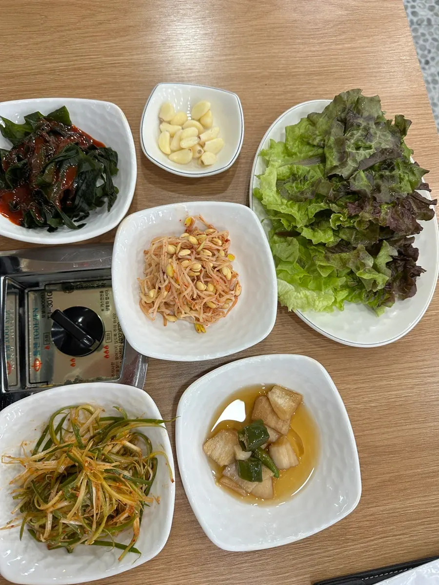 Kimchi and onion grilling together on the tabletop grill
