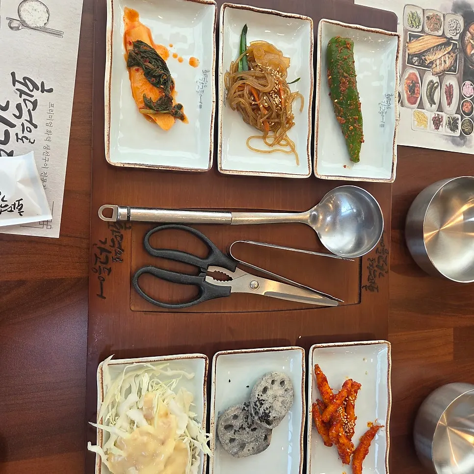 A spread of basic banchan including deodeok muchim and japchae