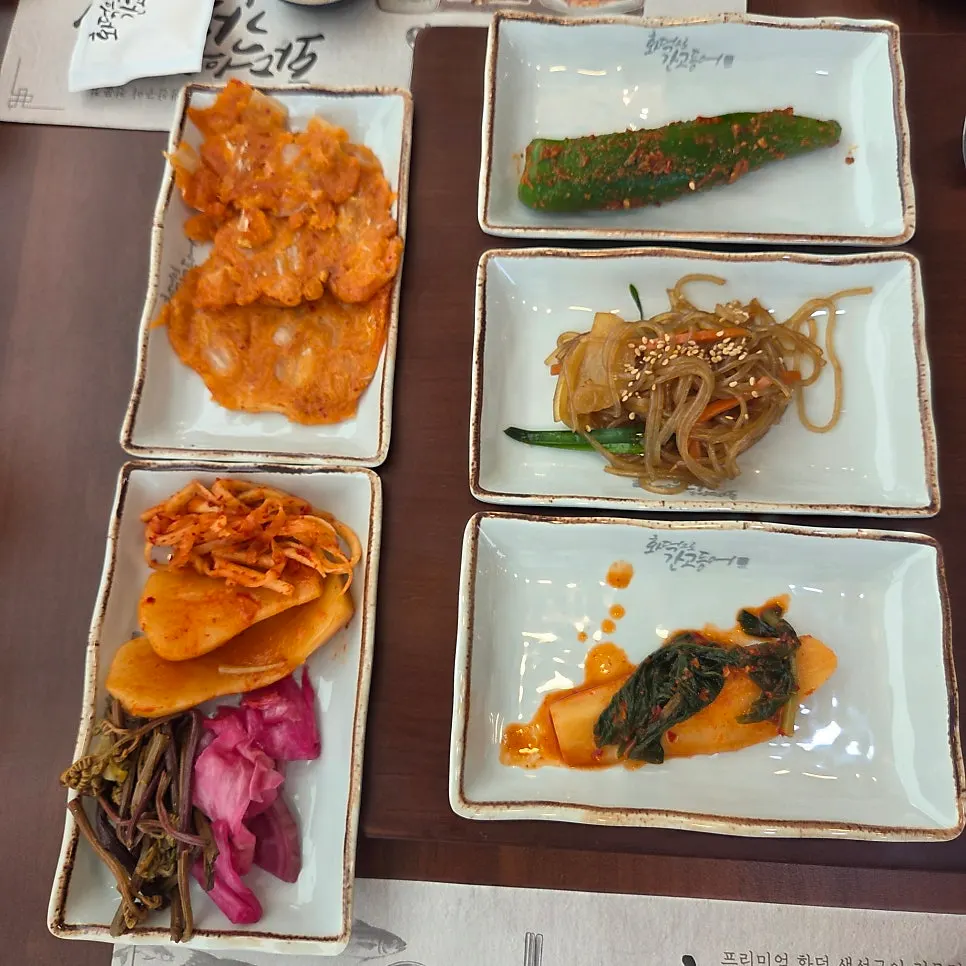 Neatly arranged banchan including seasonal kimchi