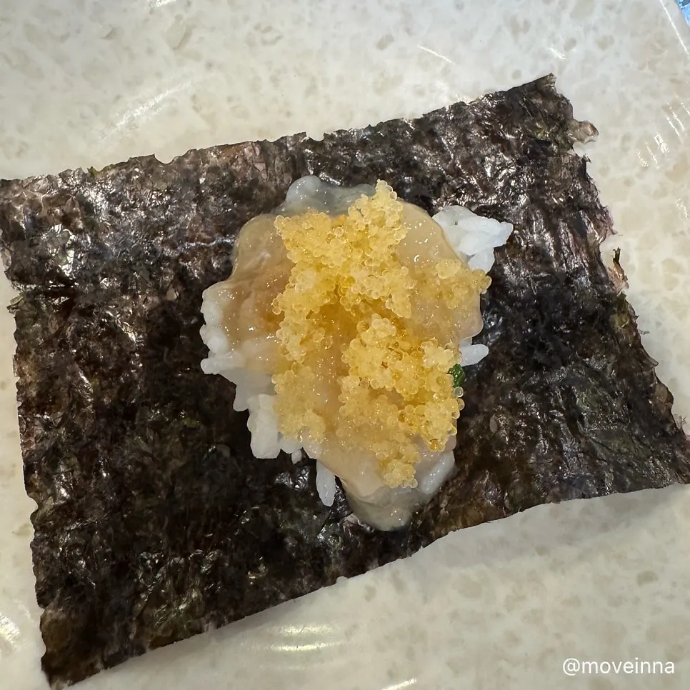 A spoonful of crab rice topped with flying fish roe