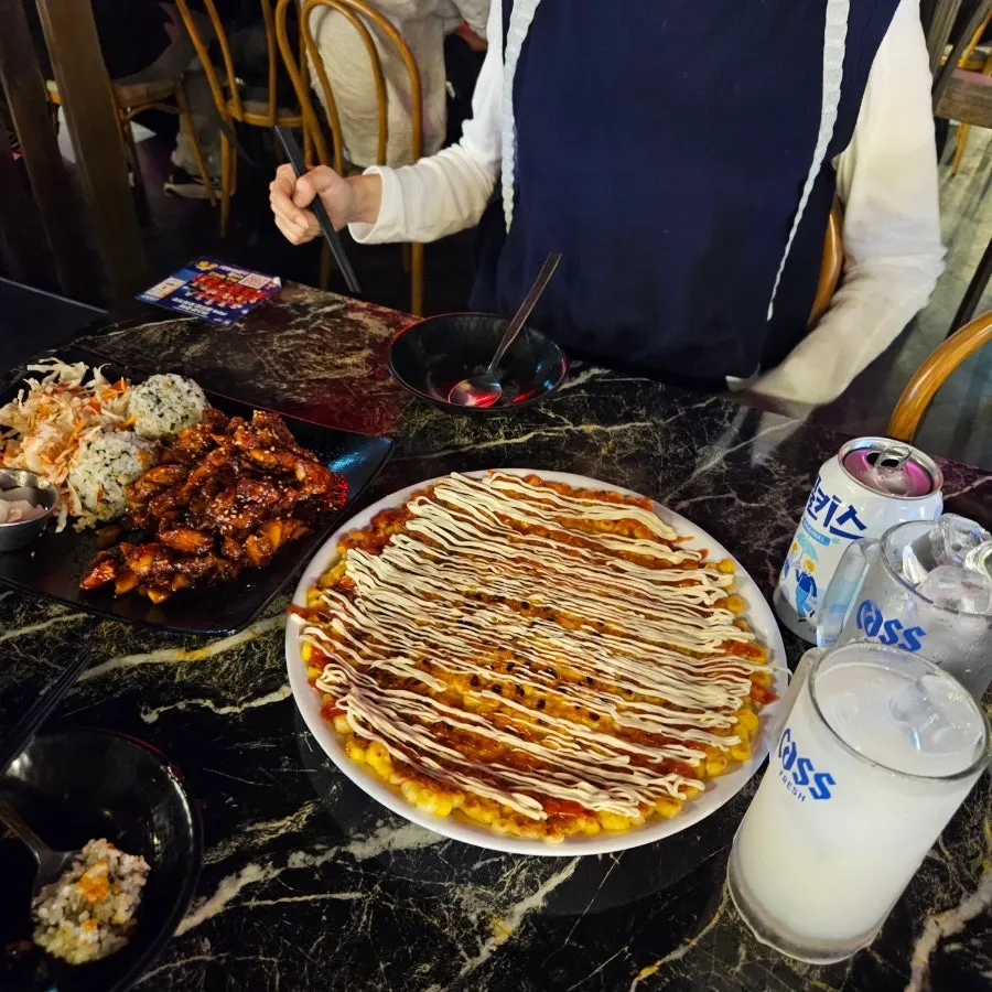 Generous spread of Jjikoba self-serve chibap and corn cheese jeon