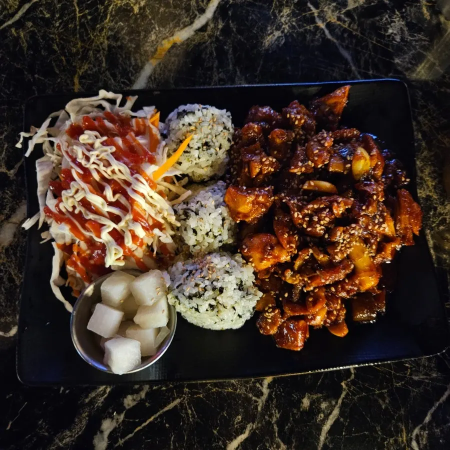 Plate of Jjikoba self-serve chibap with seasoned chicken