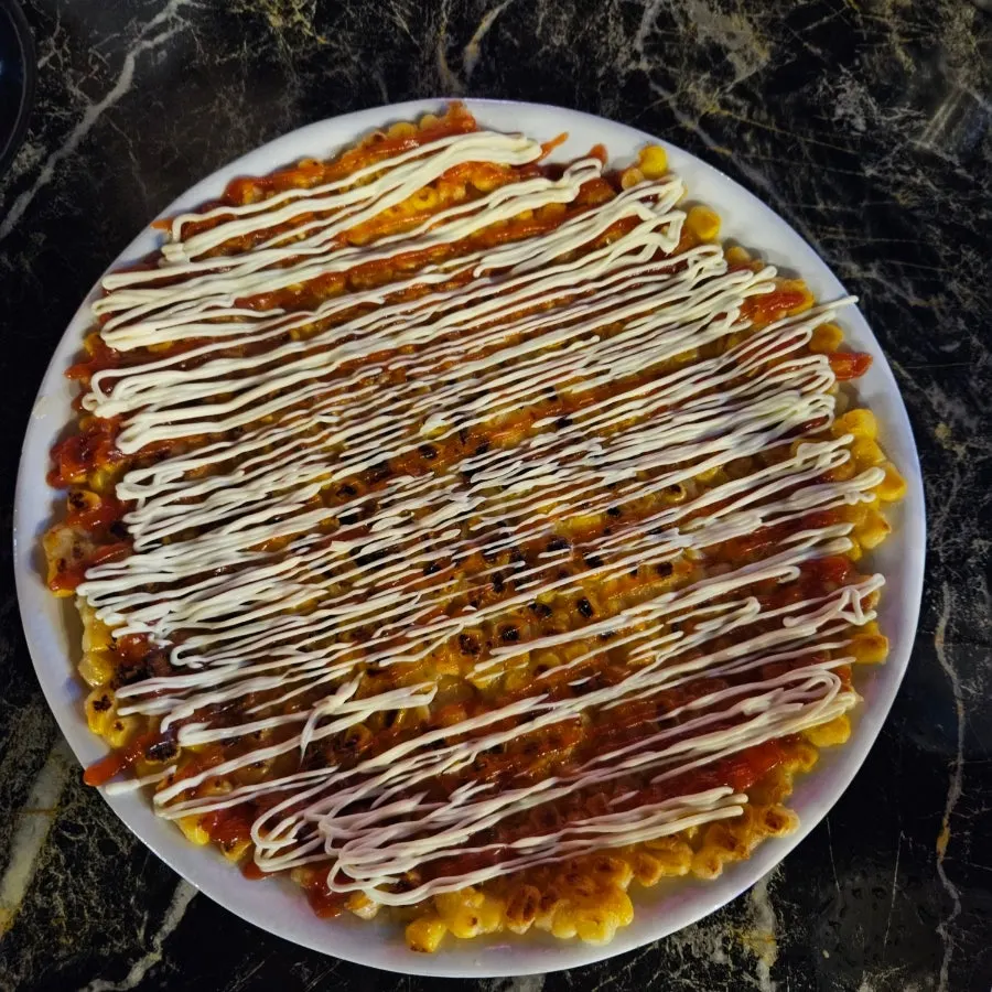 Corn cheese jeon topped with sauce and mayonnaise