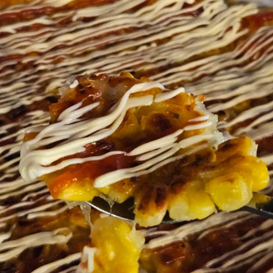 A bite taken out of the corn cheese jeon