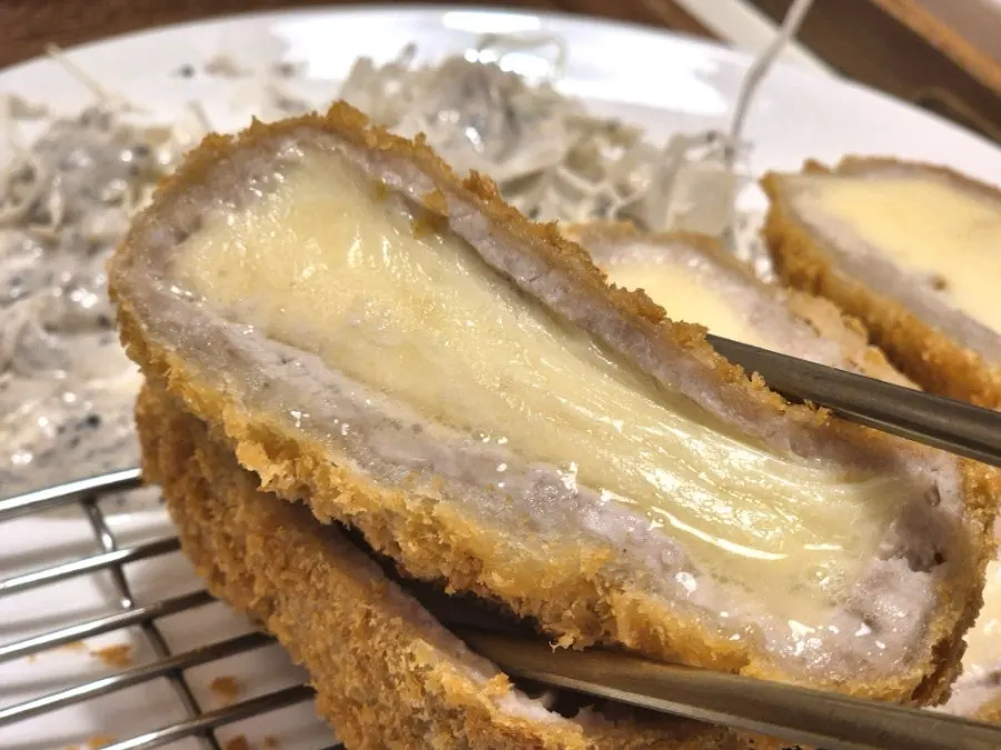 A bite of cheese-filled cutlet