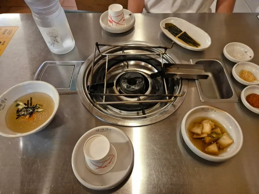Side dishes at Imdaejang including pickled onions and wild garlic leaves