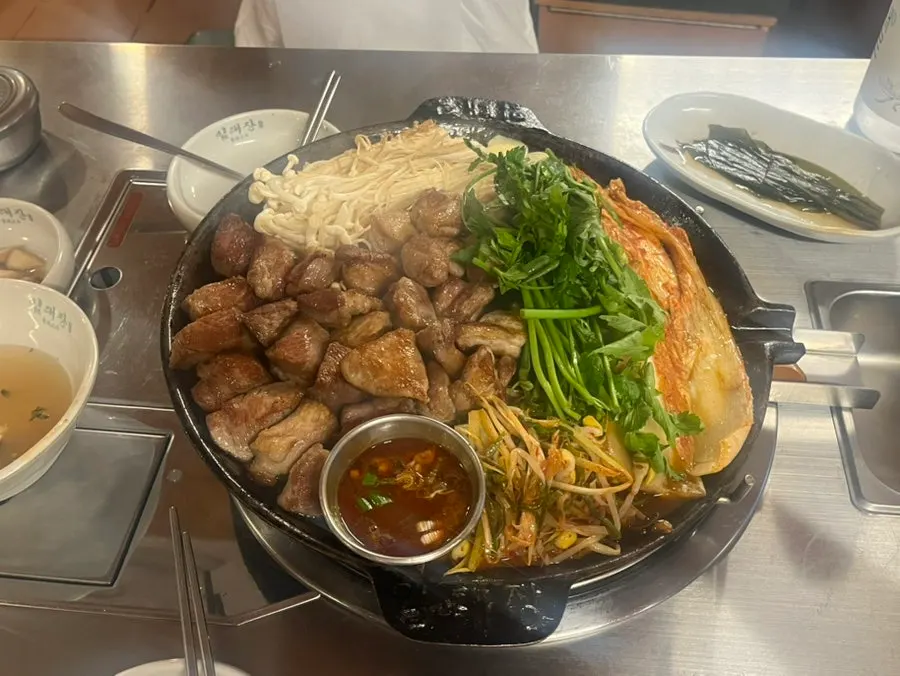 A full spread of meat served with myeol젓 sauce