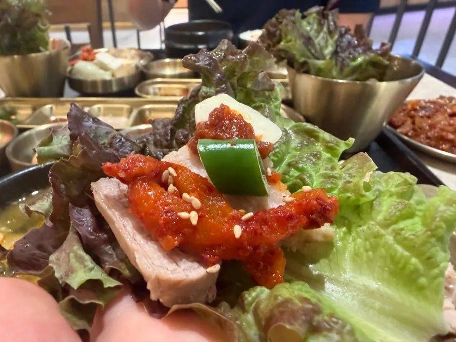 Radish kimchi served alongside bossam