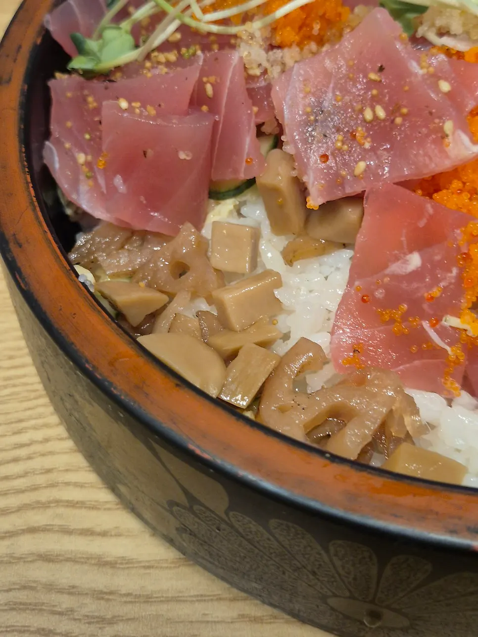 Spoonable chirashi sushi drizzled with wasabi soy sauce