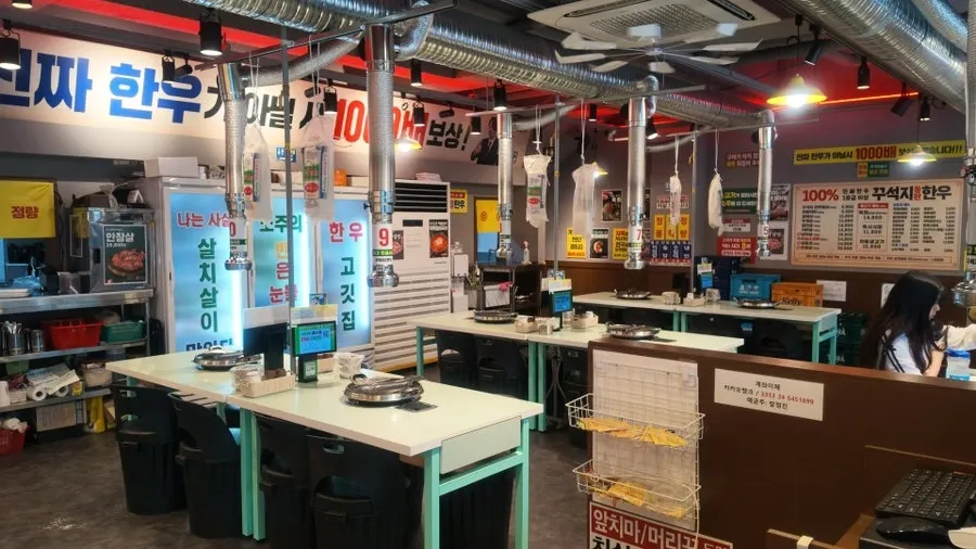 Restaurant interior with a grill installed at each table