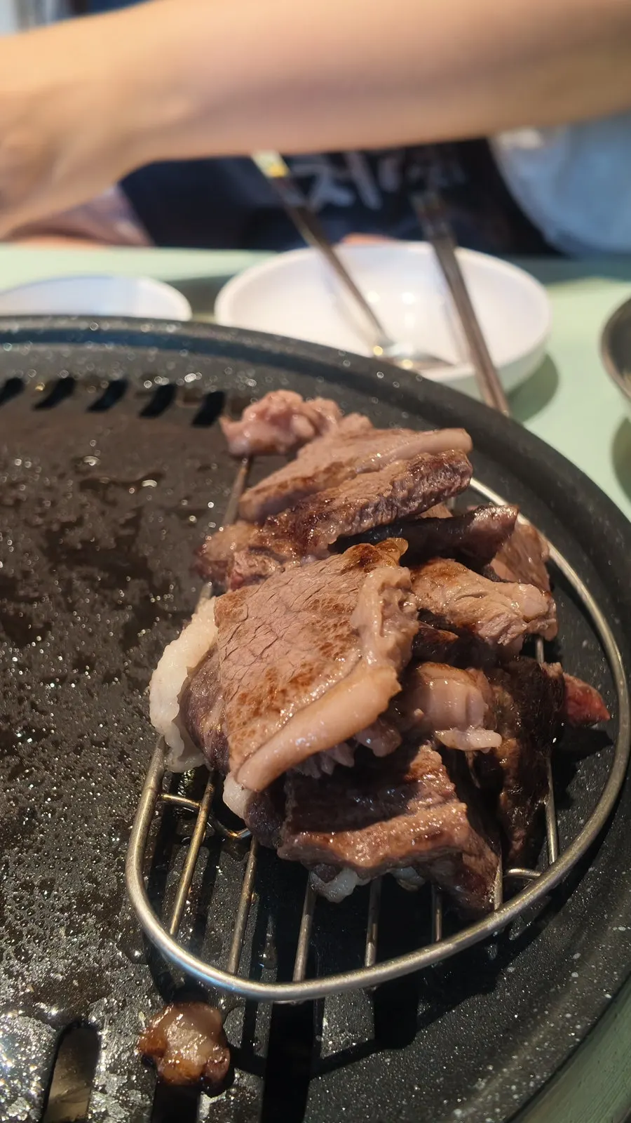 Korean beef cooking on a hot stone plate