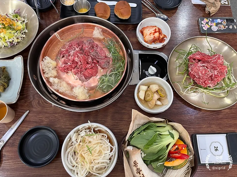 Wide shot of the table with bulgogi and side dishes