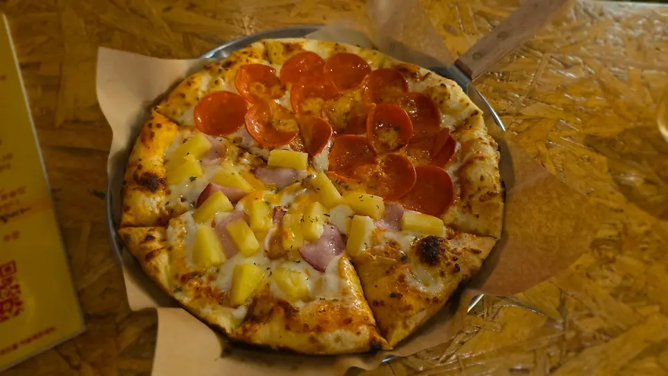 Half-and-half pizza and beer on the table