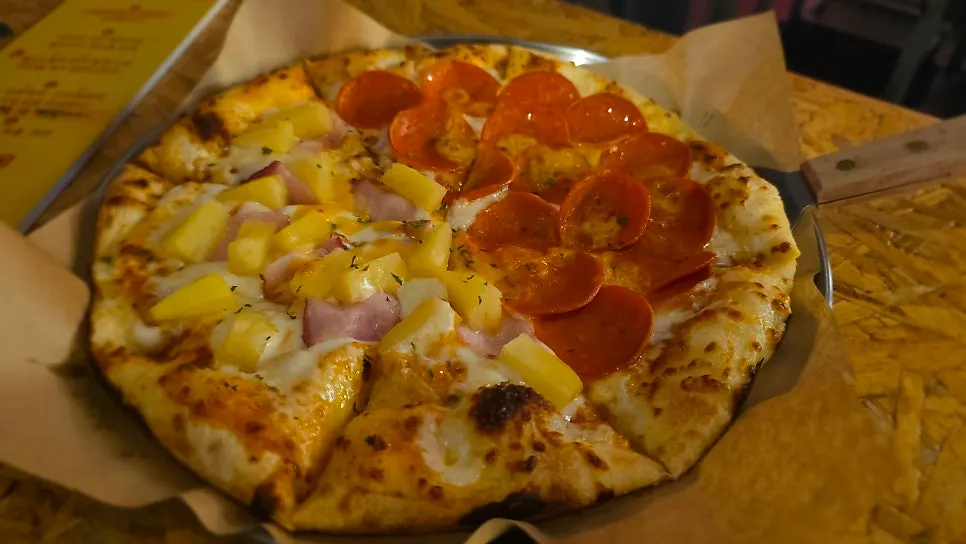 Full view of the half-and-half pizza split into two flavors