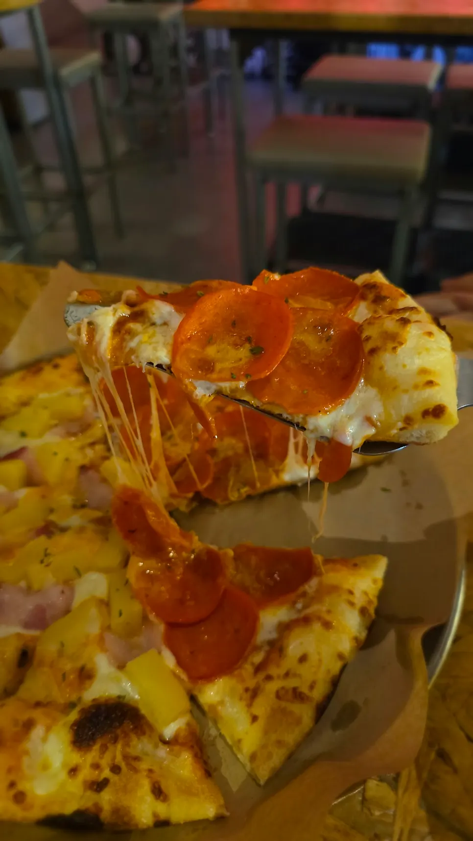 Close-up of a topping-loaded pizza slice